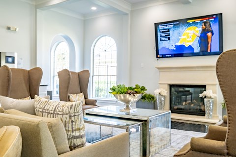 A living room with a television on the wall and a fireplace.