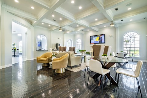 A spacious room with a television, chairs, and a dining table.