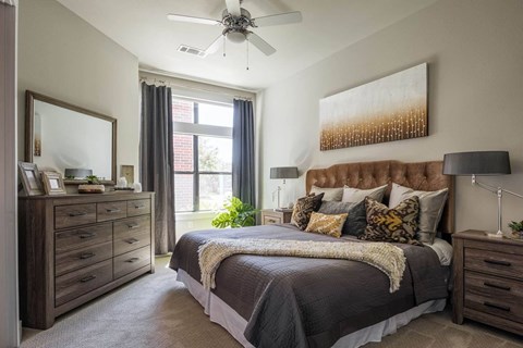 spacious bedroom with a ceiling fan at Tinsley on the Park apartments