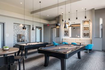 gaming lounge with billiards and shuffleboard at Tinsley on the Park apartments