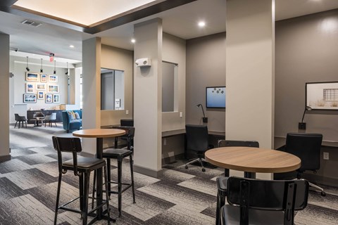 a lounge area with tables and chairs at Tinsley on the Park apartments