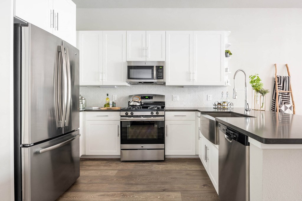 spacious kitchen with custom cabinetry and stainless appliances at Tinsley on the Park apartments