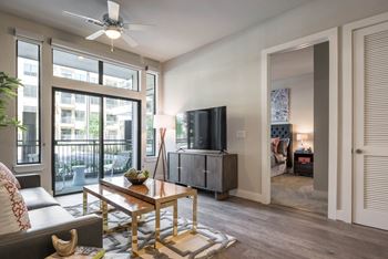 a living room with expansive windows at Tinsley on the Park apartments
