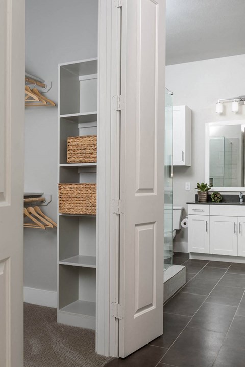 a bathroom and closet with shelving at Tinsley on the Park apartments