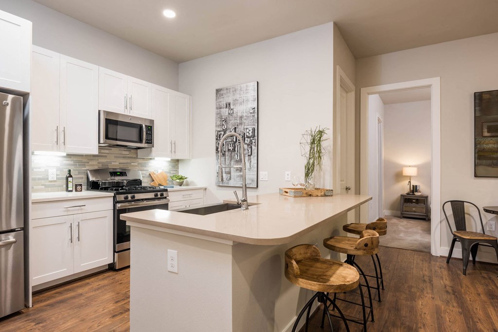 a kitchen with custom cabinetry and stainless steel appliances at Tinsley on the Park apartments