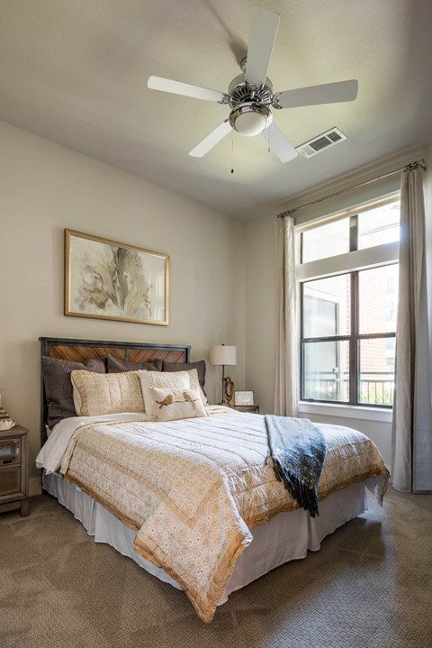 spacious bedroom with a ceiling fan at Tinsley on the Park apartments