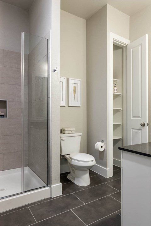 bathroom with glass-framed shower doors at Tinsley on the Park apartments