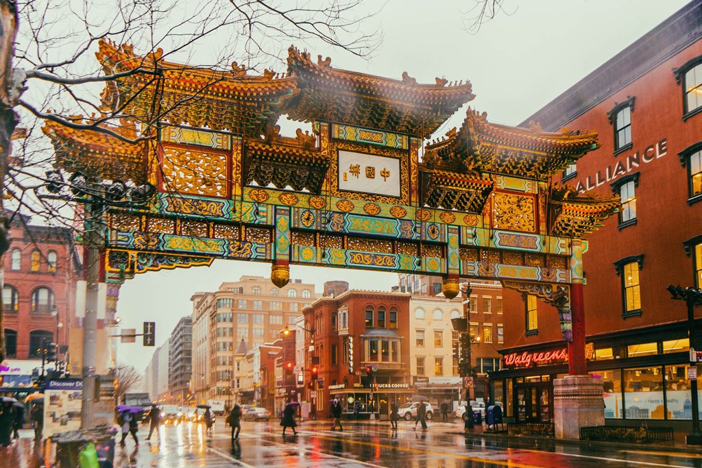 the archway of the chinatown gate on a rainy city street