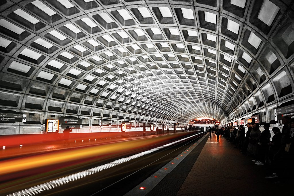 a train passing through a tunnel at a metro station