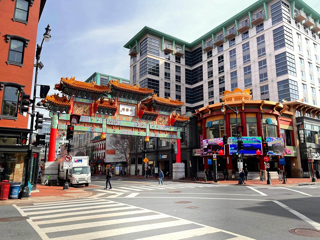 a busy city street with a large archway in the middle