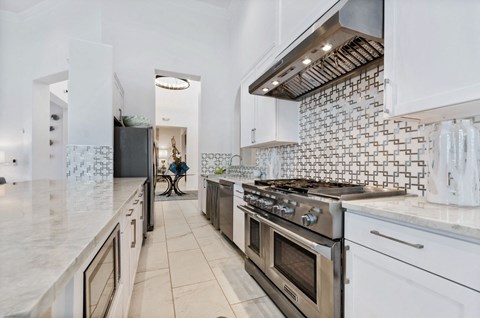 the kitchen has stainless steel appliances and marble counters