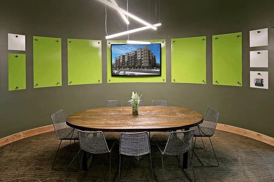 a conference room with a round table and chairs