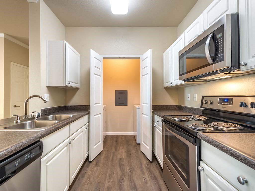 Kitchen with adjacent washer and dryer room