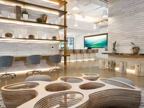 Indoor common area with bar seating at The Rey Apartments, California