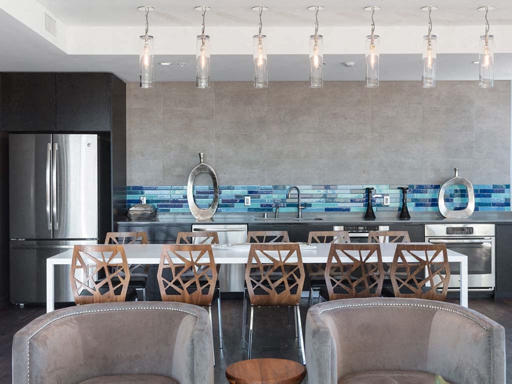 Common area with armchairs and kitchen area at Lyric, California