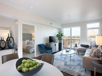 Dining room table with living room view at Lyric, California - Photo Gallery 4
