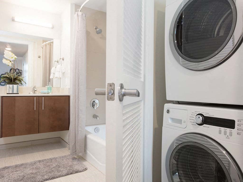 Bathroom with floating vanity and stacked washer dryer at Lyric, Walnut Creek, 94596