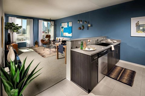 A kitchen with a sink and a fridge.