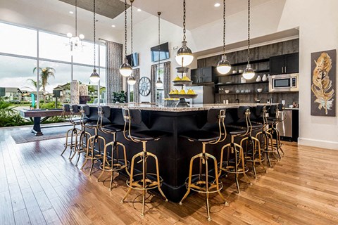 a large kitchen with a large bar and chairs