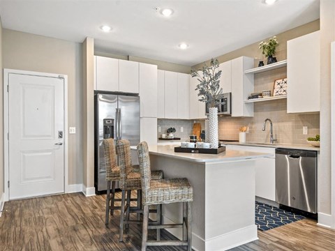 a kitchen with a bar and a refrigerator