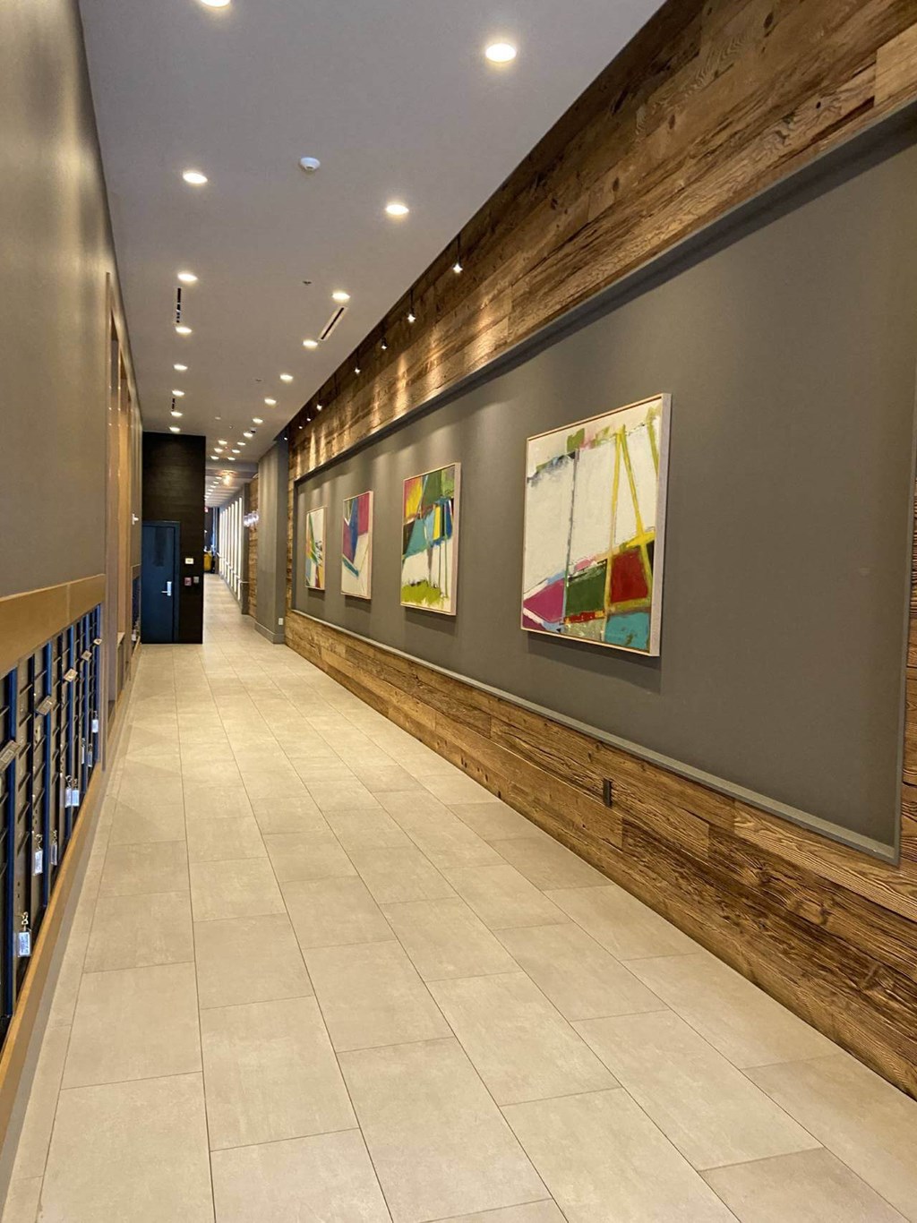 a long hallway with paintings on the wall at Tribeca NOMA apartments