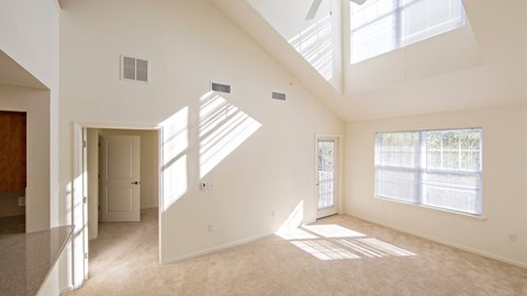 the living room and dining room of a two floor unit at Reveal Hackensack apartments