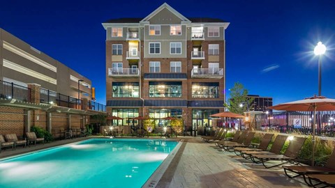 a pool at Reveal Hackensack apartments in Hackensack New Jersey at night