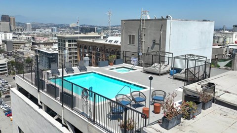 A pool on a balcony overlooking a city.
