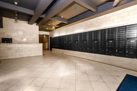 A hallway with a row of lockers on the right side.