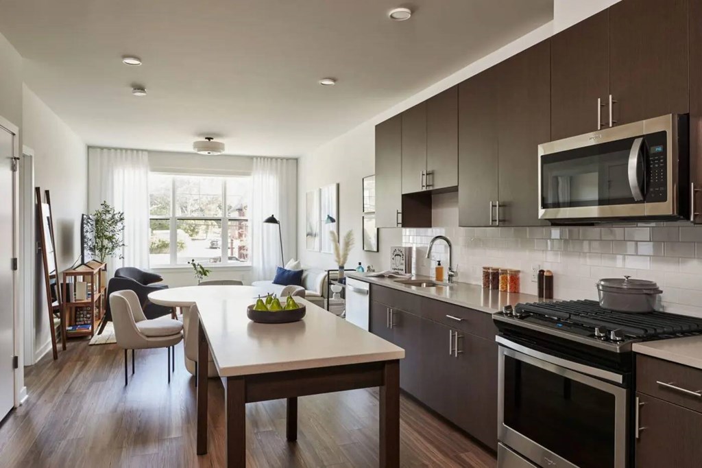 A modern kitchen with a dining table and chairs.