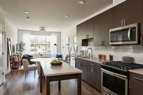 A modern kitchen with a dining table and chairs.
