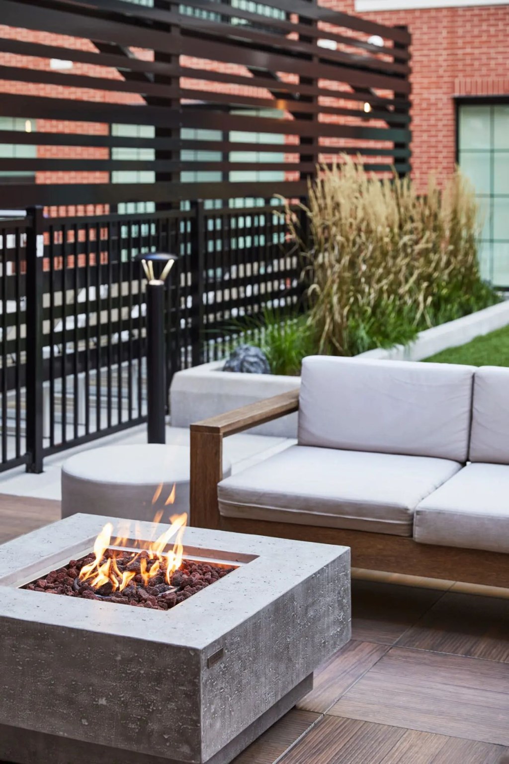A modern outdoor seating area with a fire pit.