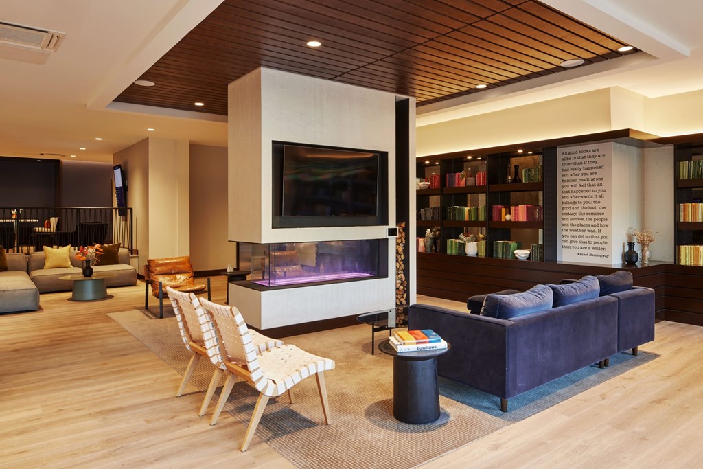 A modern living room with a flat screen TV and a fireplace.