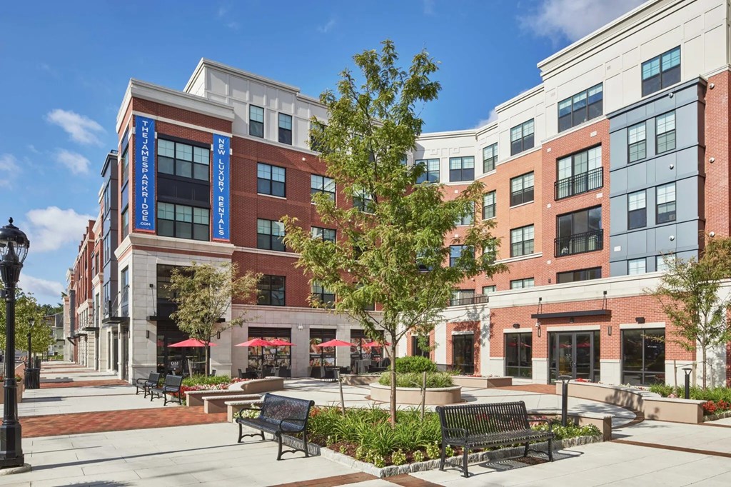 A street view of a city with a building in the background.
