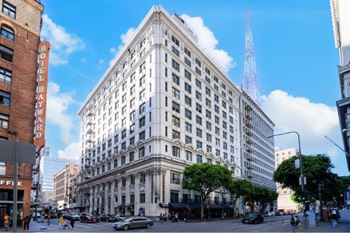 A large white building with a red tower in the background.