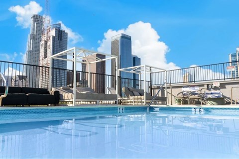 A pool with a cityscape in the background.