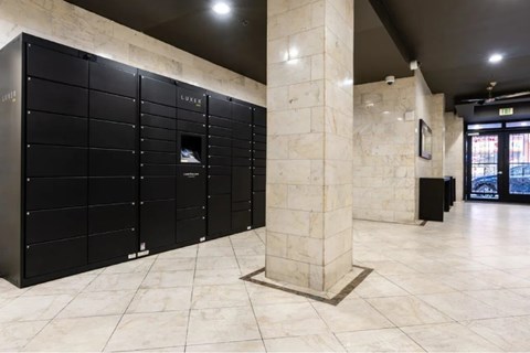 A row of black lockers with the word "LUXE" on them.