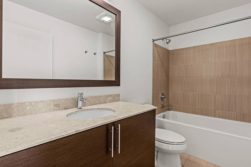 A bathroom with a sink, toilet, and bathtub.