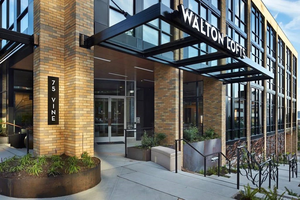 The front of a building with the name Walton Lofts on it.