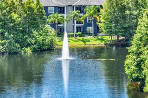 a fountain in a pond at Verano apartments