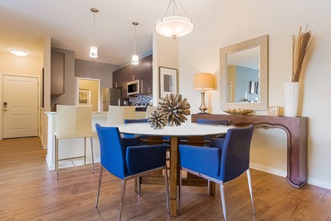 A dining room with a table and chairs.