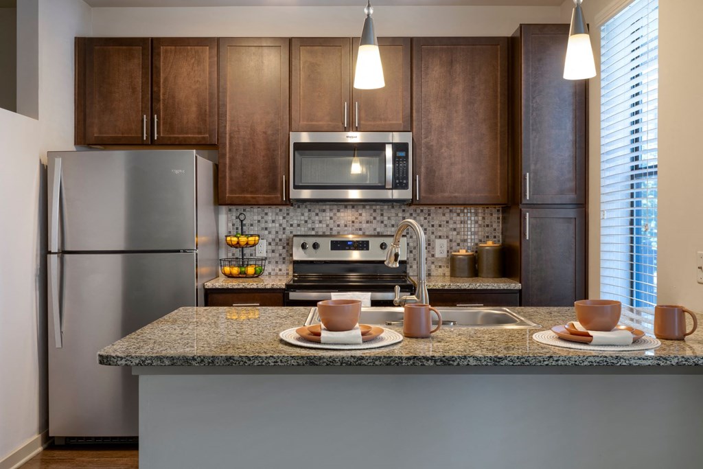 kitchen with designer lighting and stainless appliances at Artisan on 18th, Nashville, Tennessee