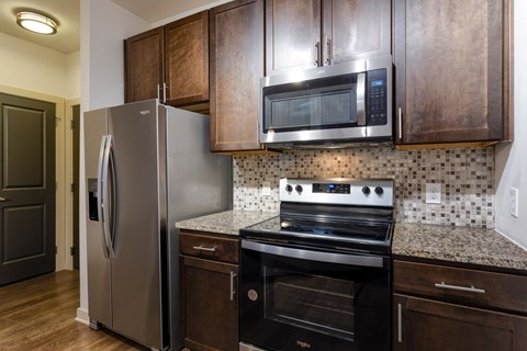 a kitchen with stainless steel appliances and wooden cabinets