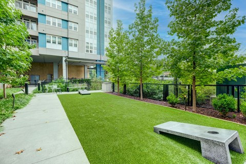 Outdoor courtyard with corn hole at Berkshire Chapel Hill apartments