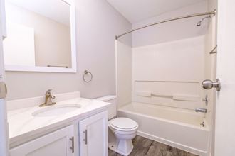 a bathroom with a toilet sink and bathtub - Photo Gallery 4