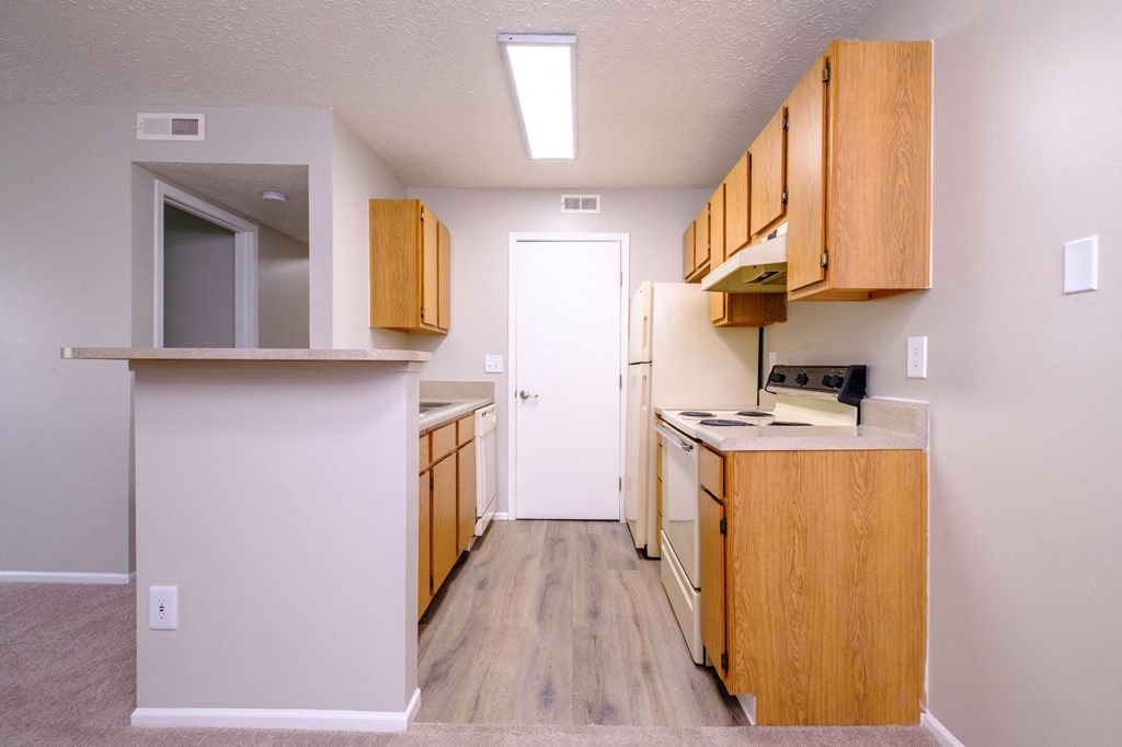 a spacious kitchen with wooden cabinetry