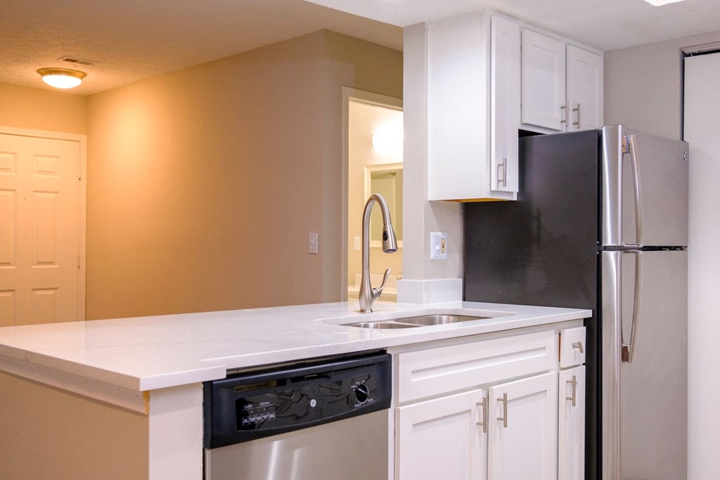 a kitchen with white cabinets