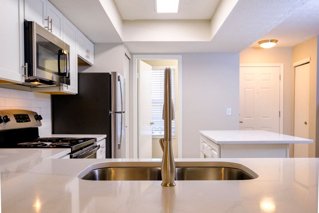 a kitchen with a sink and a refrigerator