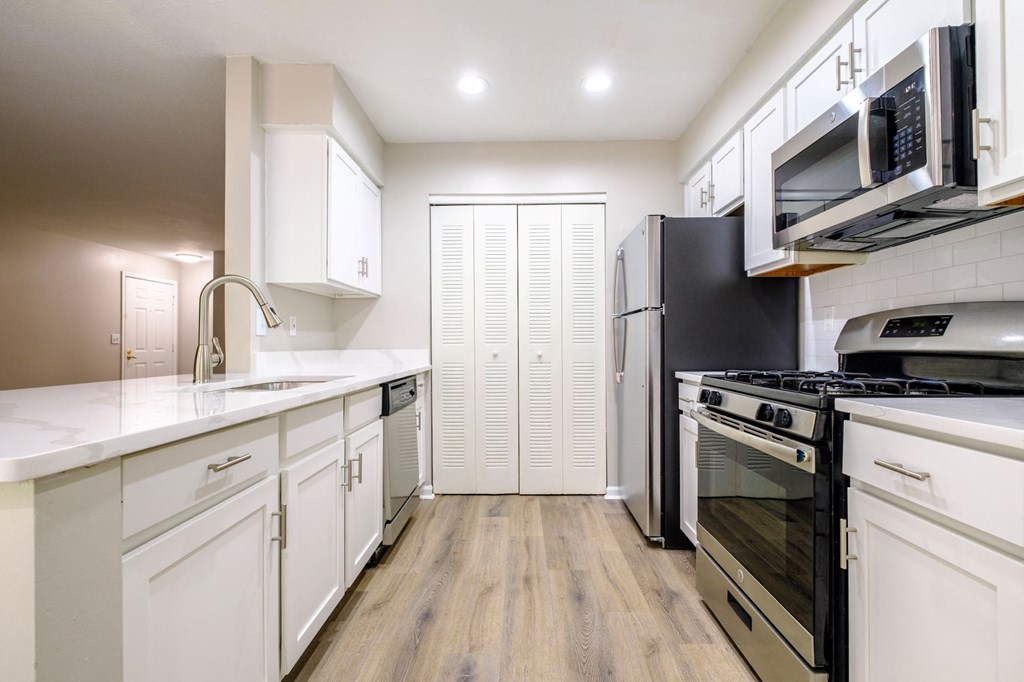a kitchen with white cabinetry
