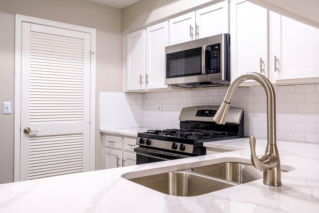 a kitchen with white cabinets